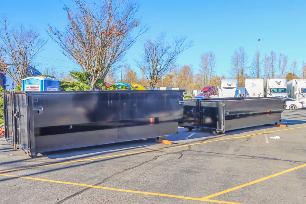 Professional dumpster rental service with roll-off container on residential driveway in Clarkston